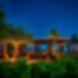 A vibrant outdoor dining setting with greenery and ambient lighting near Damac Hills 2